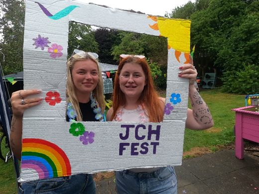 Picture of 2 ladies smiling holding the JCH photo frame.